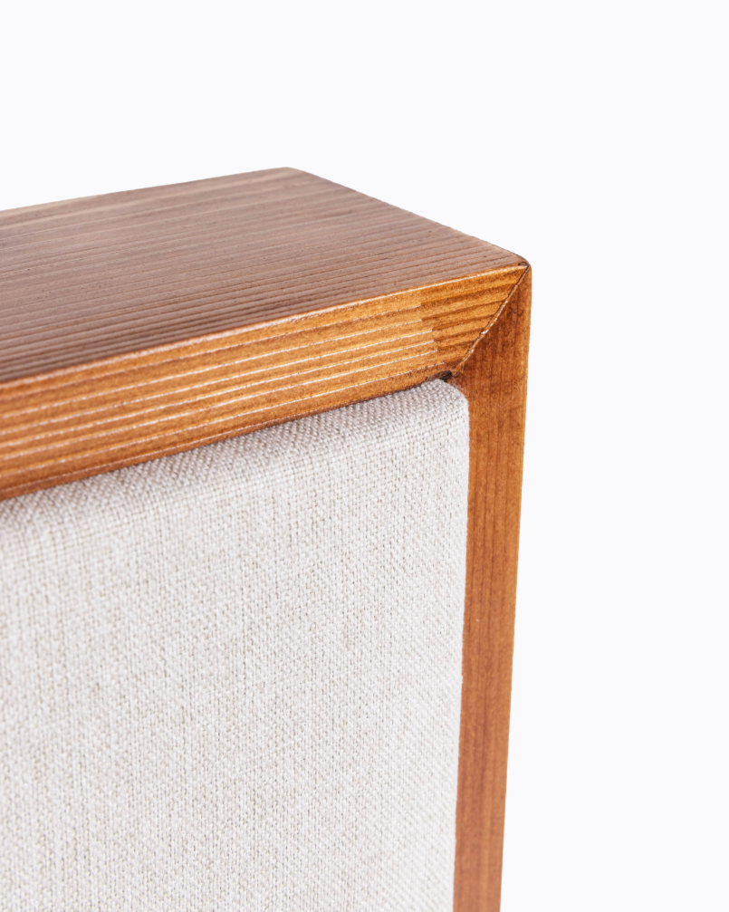 Wooden side table corner with a white fabric surface | Room Control Authority